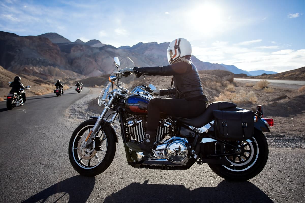 Man riding a touring motorcycle on a scenic open road